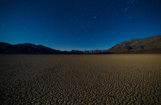 Racetrack Playa in Death Valley National Park on a clear night with endless stars in the sky
