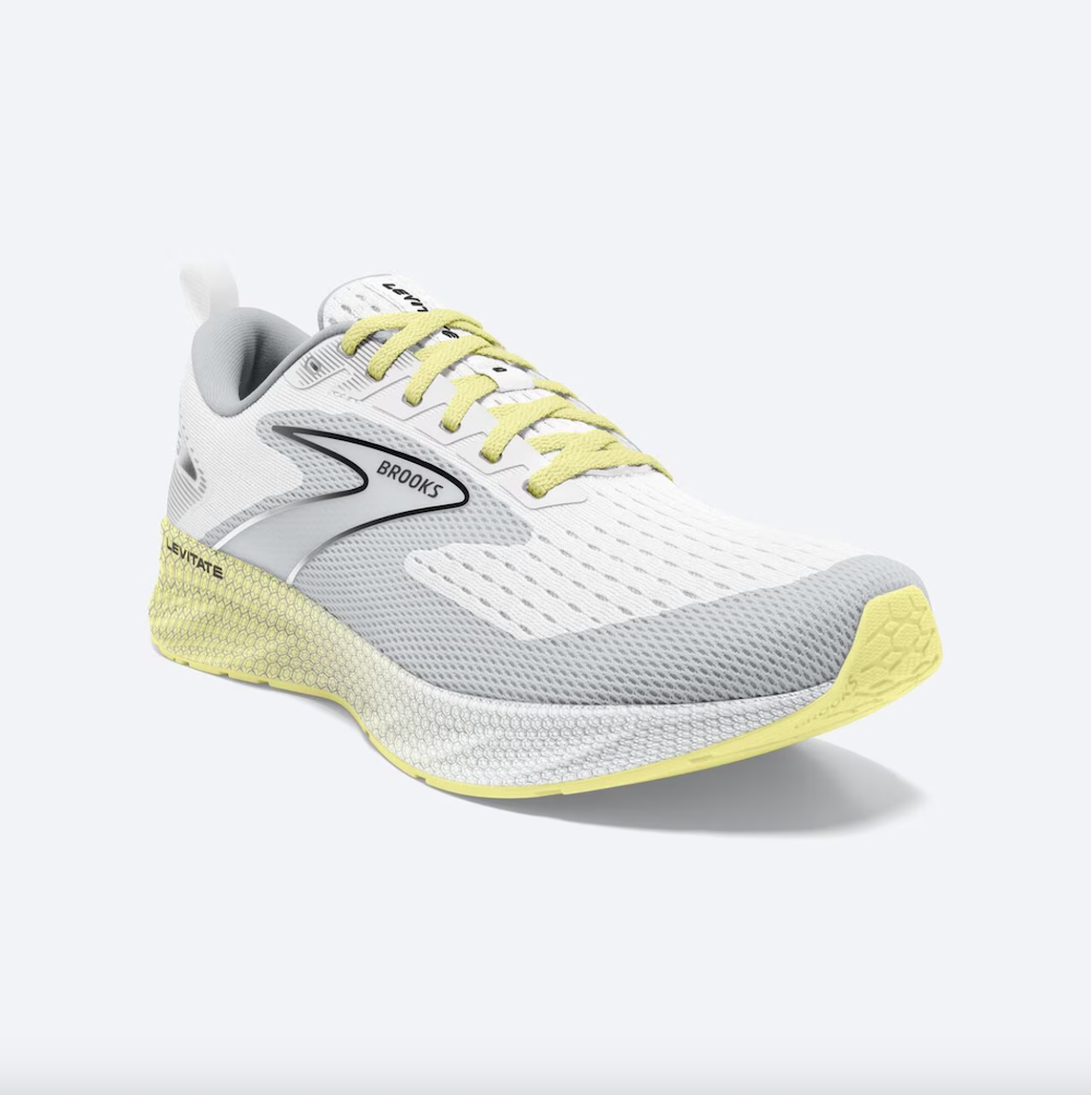 A white and gray running shoe with neon yellow and black accents