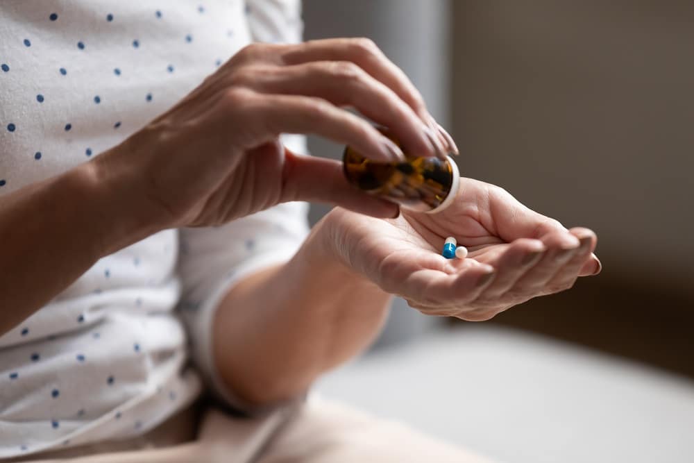 Close,Up,60s,Old,Woman,Pours,Out,From,Bottle,Pills