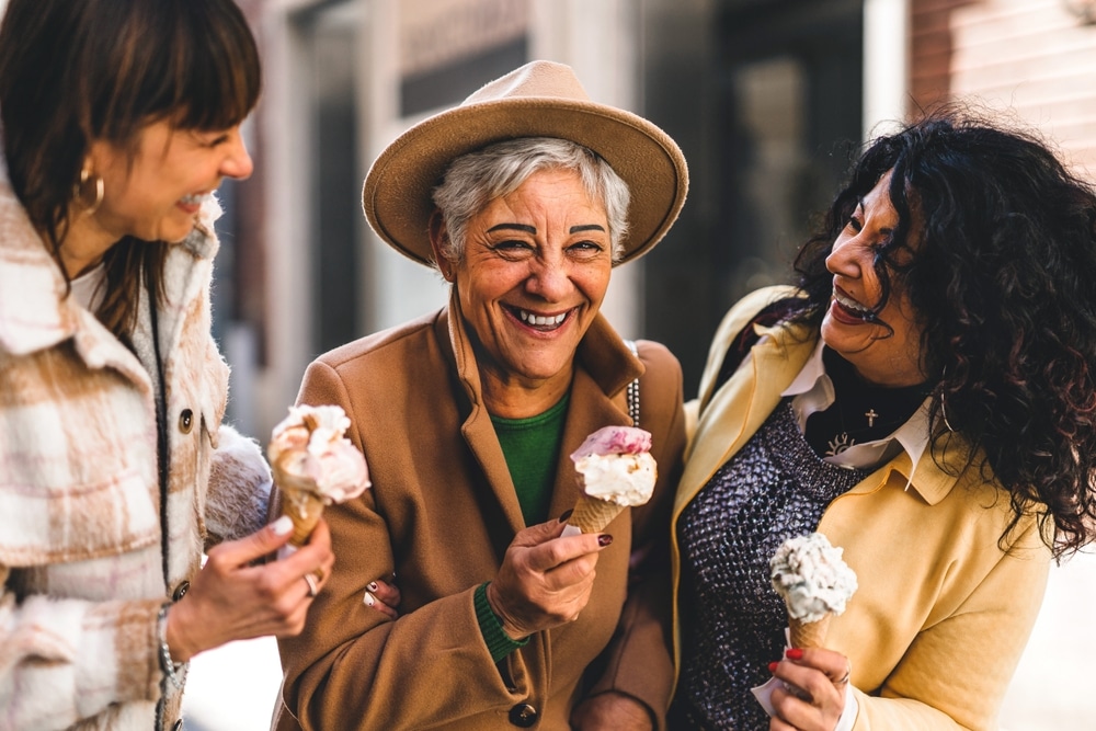 Group,Of,Happy,Women,Eating,Ice,Cream,Outdoors,At,City