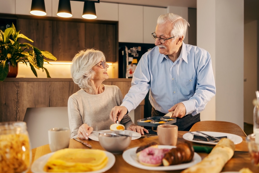 A,Senior,Man,Is,Serving,Breakfast,To,His,Wife,At