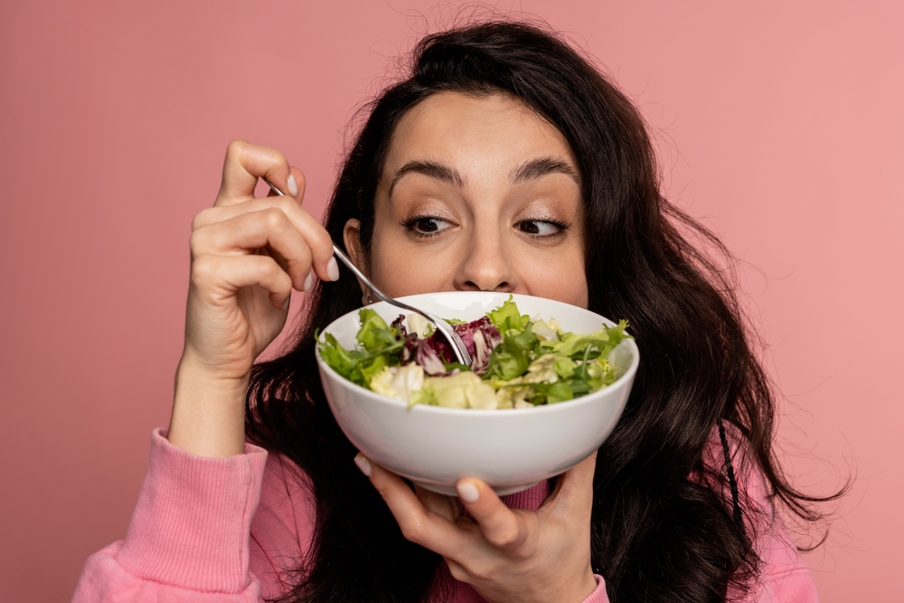 Brunette eating salad