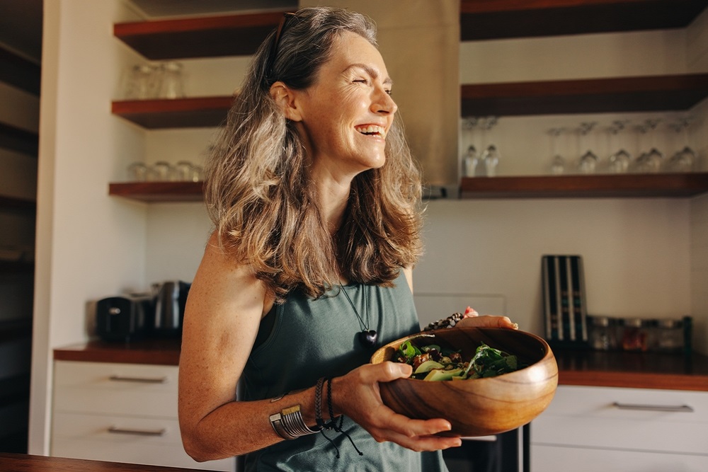 Aging,Woman,Smiling,Happily,While,Holding,A,Buddha,Bowl,In