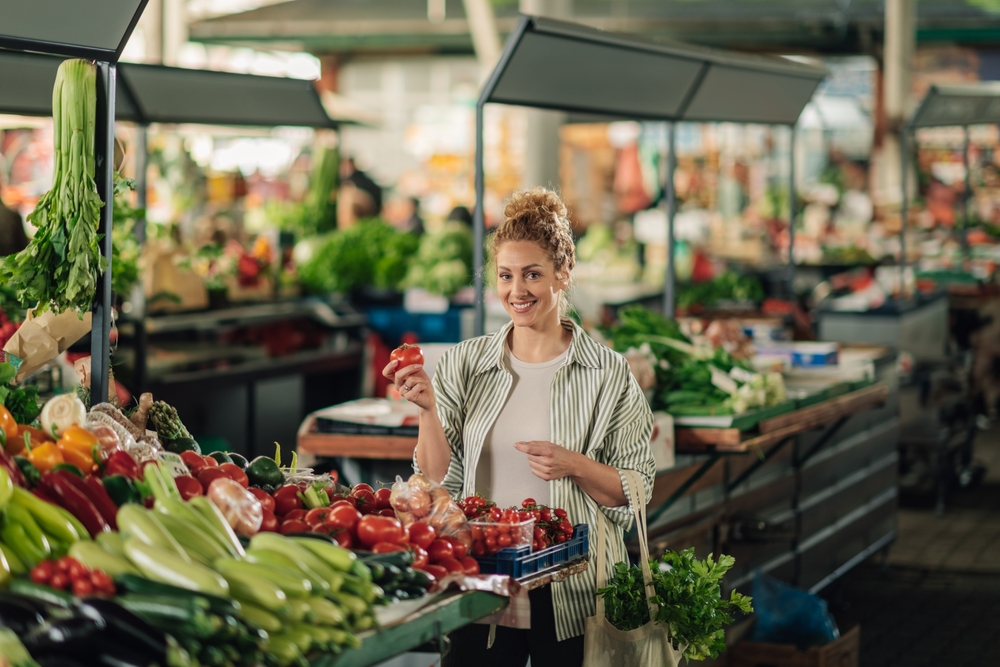 Portrait,Of,A,Happy,Female,Customer,Standing,At,Food,Market