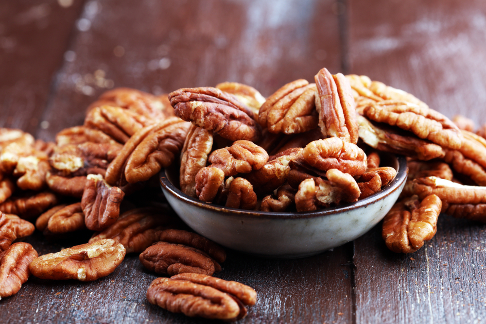 Pecan,Nuts,On,A,Rustic,Wooden,Table,And,Pecan,Nuts